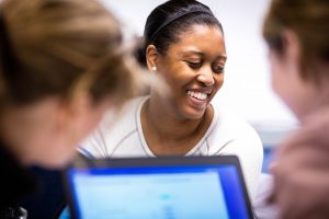 Student smiling in a classroom