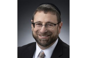 A headshot of David Silberberg wearing a black blazer and a white shirt.